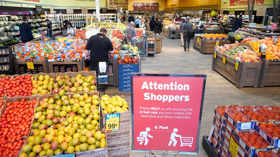 People shopping for fruit and veg at the supermarket