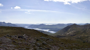 View from the rocky top of Beinn nan Aighenan on a partly-cloudy day.