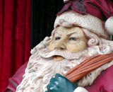 Dutch statue of Sinterklaas (Santa Claus) with red clothing, a long white beard and a sack of presents slung over his shoulder