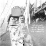 Charles Hladky (standing) with buddy holding Japanese banner. Okinawa, Japan at end of war. Charles Hladky (standing) with buddy holding Japanese banner. Okinawa, Japan at end of war.