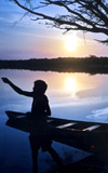 Local man fishing in Rio Urubu, Brazil, at sunset