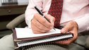A psychotherapist making notes during an appointment