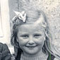 A school photograph taken at Clonelly Primary School in the early 1950's. L to R, Eva's siter Edith, brother John and Eva herself holiding her doll
