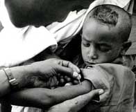 Image of a young boy receiving vacination against smallpox