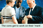The cons get to work on their 'mark'