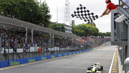Jenson Button taking the chequered flag at the Brazilian Grand Prix last year, when he claimed the world title
