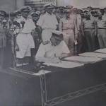 Admiral Sir Bruce Fraser signing the surrender terms on behalf of the British Government and the Crown.General McArthur is to the left of the picture Admiral Sir Bruce Fraser signing the surrender terms on behalf of the British Government and the Crown.General McArthur is to the left of the picture