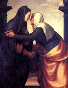 Mary telling the news to Elizabeth, who is clasping her hand and hugging her