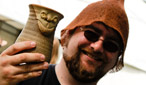 A punter arrives at the festival, mug in hand.