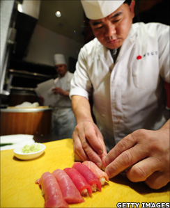 Sushi chef prepares sushi from a bluefin tuna
